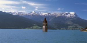 italy   april 28 the old bell tower 14th century of curon venosta church rising out of the waters of the artificial lake of resia, trentino alto adige, italy photo by deagostinigetty images