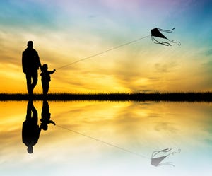 illustration of father and son with kite at sunset