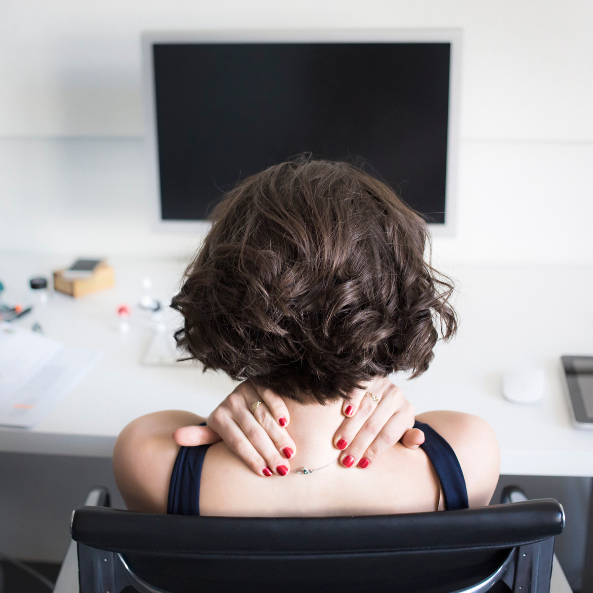 woman in pain at desk