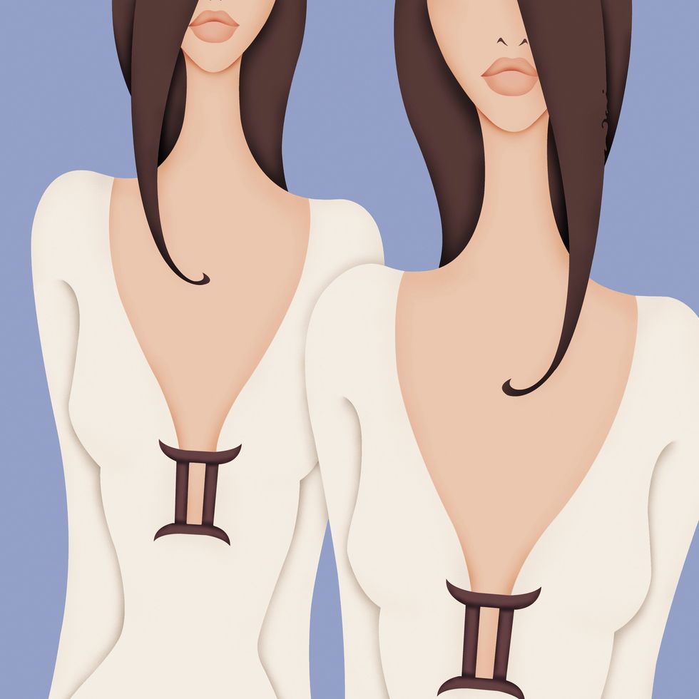 Beautiful twin women wearing dresses with Gemini symbol brooch