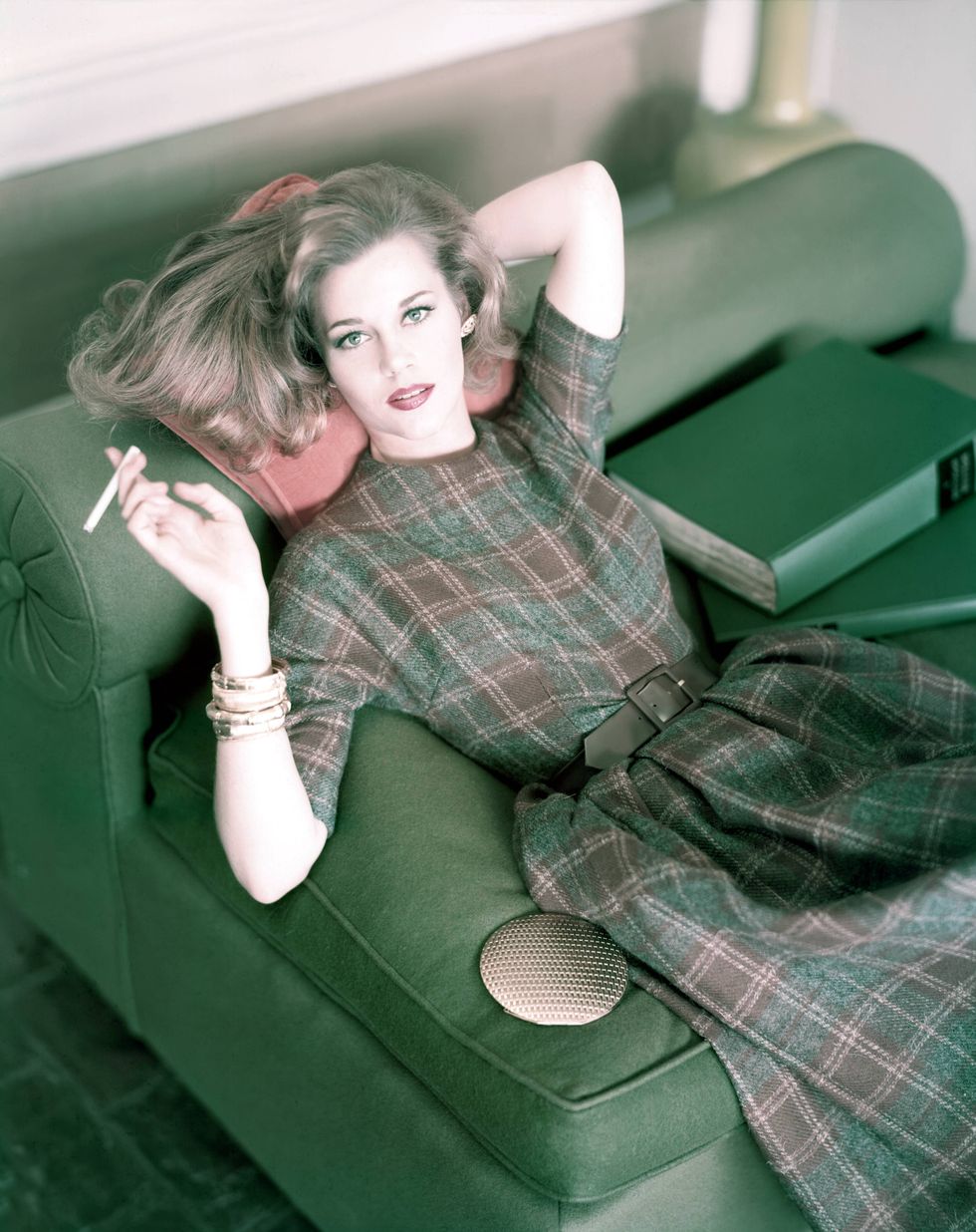 jane fonda with cigarette wearing plaid wool dress in brown and muted grey, cinched at the waist with brown suede belt photo by horst p horstconde nast via getty images