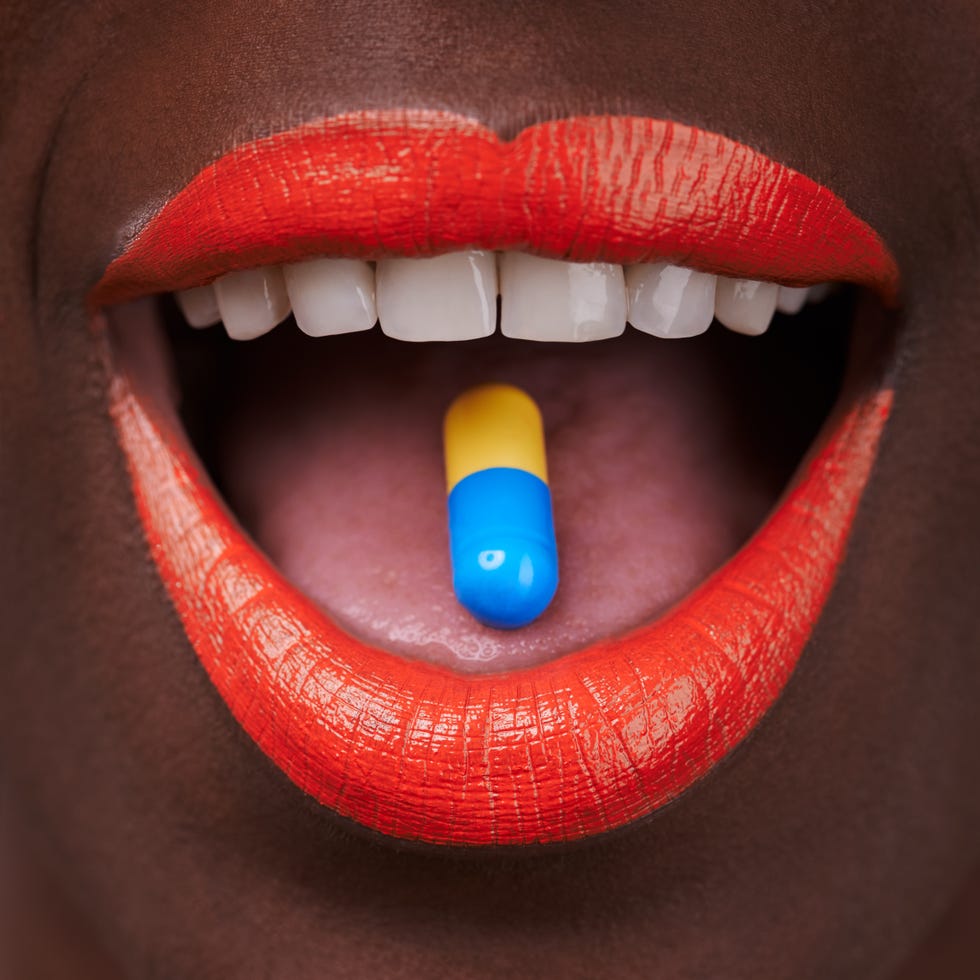 cropped view of an african woman with bright red lips taking a pillhttp19515417881dataicollagepishoots783674jpg
