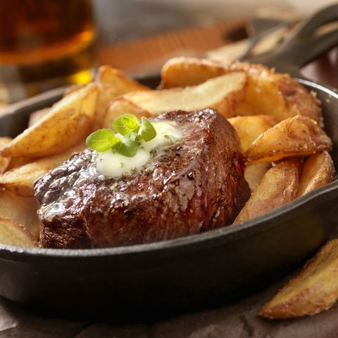 steak fillet seasoned with sea salt, fresh cracked pepper topped with a herb compound butter, hand cut fries and a beer photographed on hasselblad h3d2 39mb camera