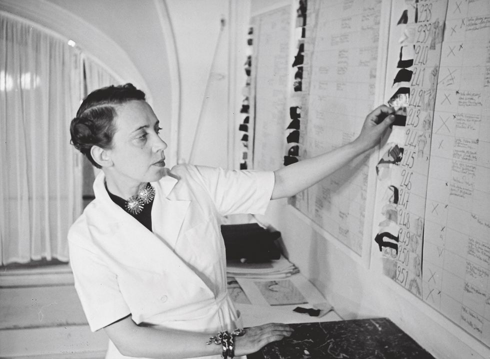 elsa schiaparelli studying the charts of her new collection
