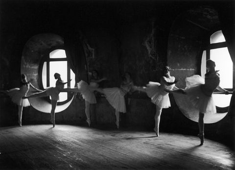 Ballerinas at barre against round window