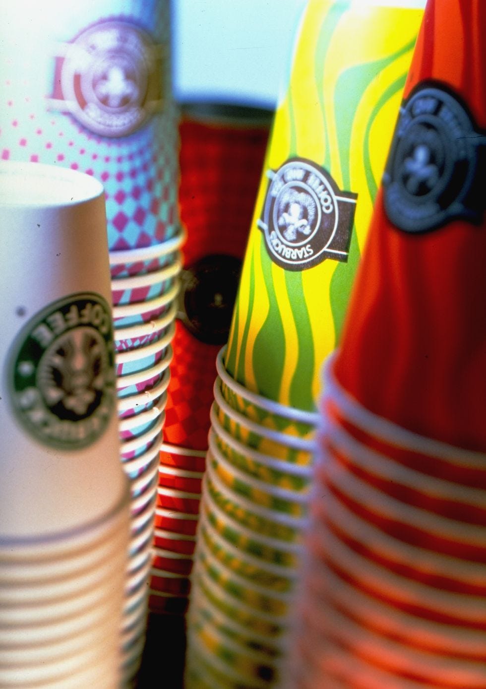 Stacks of brightly colored coffee cups a