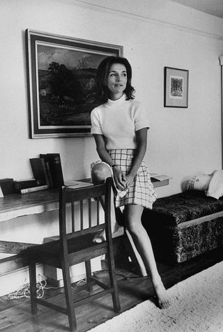 princess lee radziwill wearing a tweeded skirt, allowing her feet some breathing air while resting on top of the wooden desk shelf in her room  photo by pierre boulatthe life picture collection via getty images