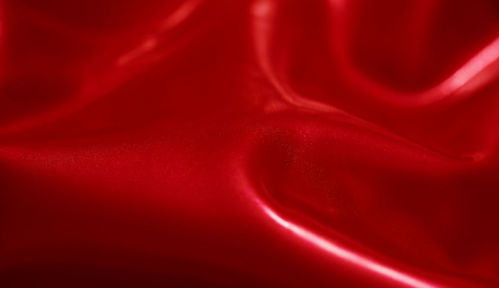 horizontal shot of shiny latex background, texturedred color
