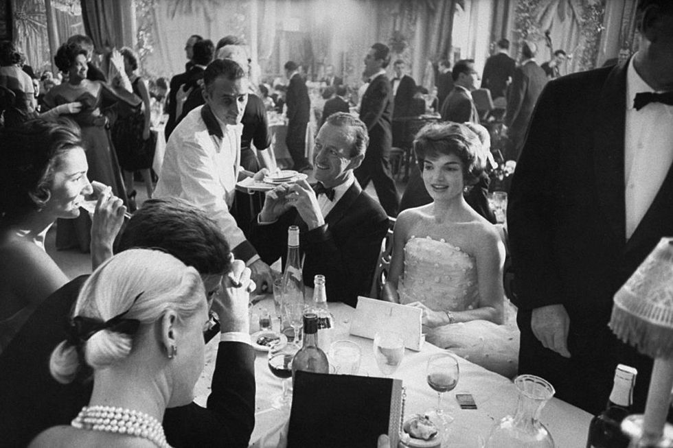 1956 waiter clearing dishes fr table in front of actor david niven 3r sitting next to sen jack kennedys wife jackie 2r w others dining at society gala sponsored by wife of us amb to cuba, in the ballroom of the waldorf astoria hotel at the far left is jackies sister caroline lee bouvier later canfield, radziwill, and ross photo by yale joelthe life picture collection via getty images
