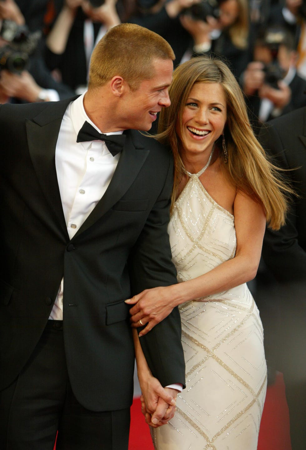 cannes, france may 13 actors brad pitt and jennifer aniston attend the world premiere of epic movie troy at le palais de festival on may 13, 2004 in cannes, france aniston wears a dress by versace photo by dave hogangetty images