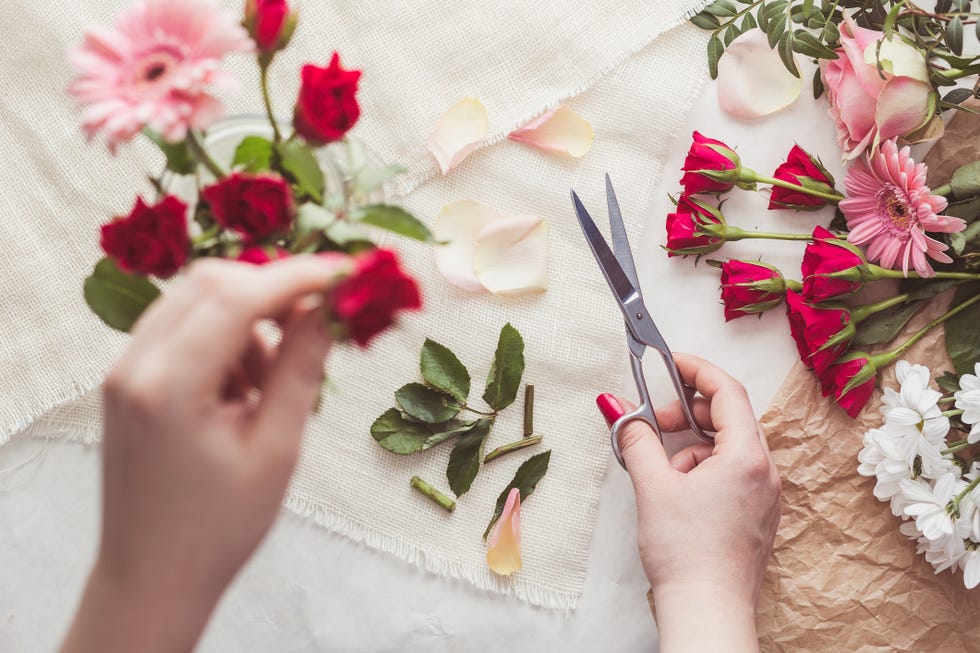 florist preparing flowers to make charming bouquet