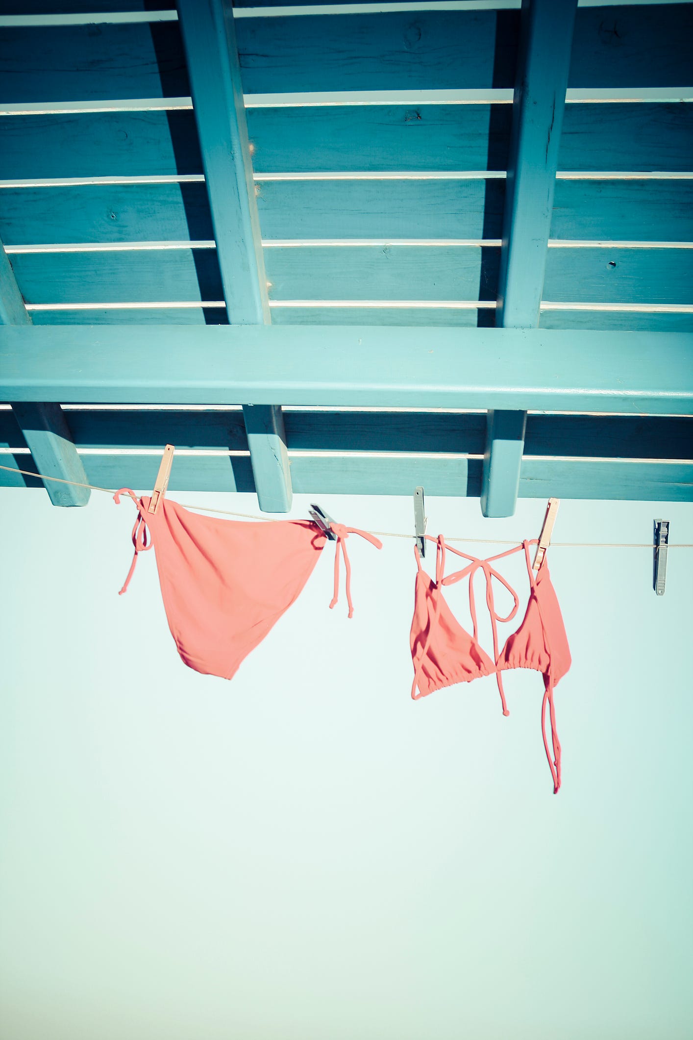 Laundry, Turquoise, Clothes hanger, Pink, Room, Line, Window, Undergarment, 