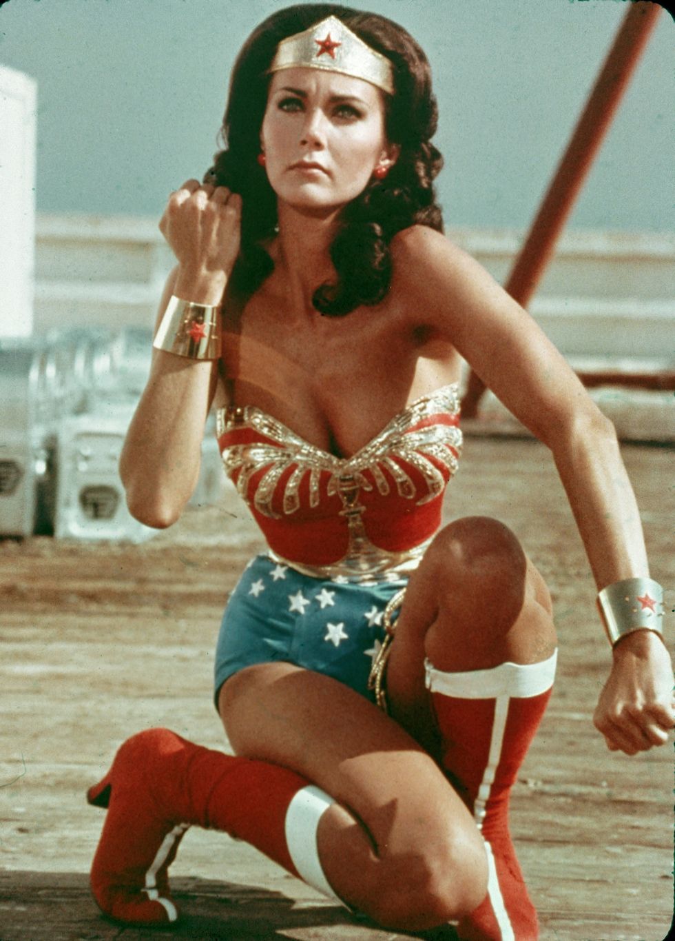 american actor lynda carter kneels on the ground and bears her forearm in a still from the television series wonder woman photo by warner brothersgetty images