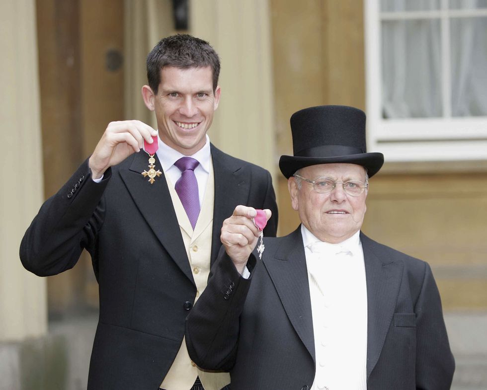 london, july 7 no uk sales for 28 days british tennis player tim henman l poses with his obe for services to lawn tennis alongside steeplejack fred dibnah r with his mbe for services to heritage and broadcasting that they received from hm queen elizabeth ii during an investiture ceremony on july 7, 2004, at buckingham palace in london photo by rotagetty images