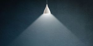 illustration of a lamp illuminating a dark empty room