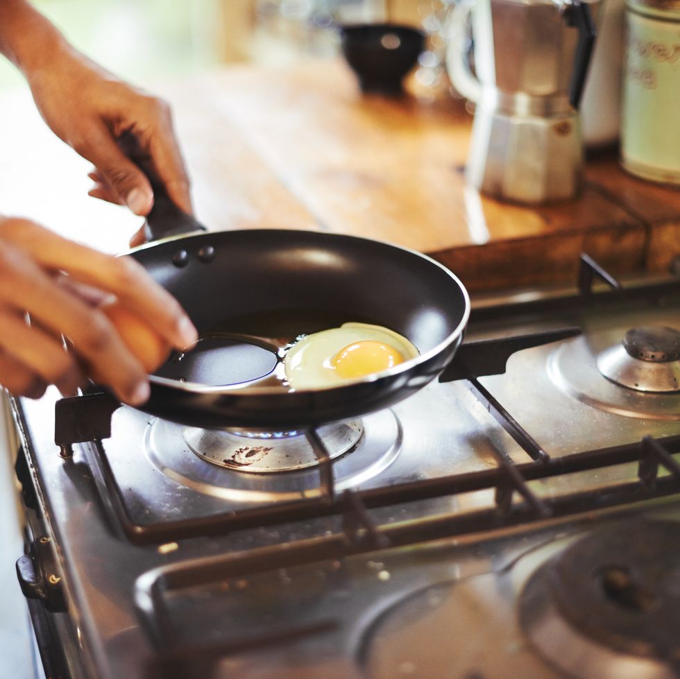 cropped shot of a man making fried eggs for breakfasthttp19515417881dataicollagepushoots806370jpg