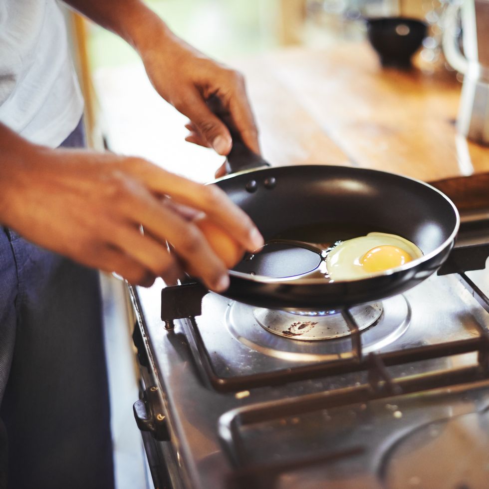 cropped shot of a man making fried eggs for breakfasthttp19515417881dataicollagepushoots806370jpg