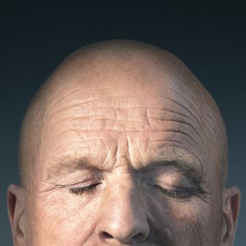 studio photograph of middle aged mans head with eyes closed