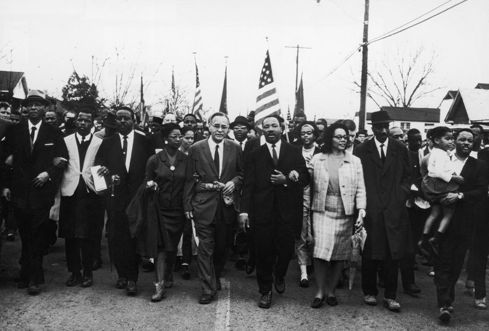 circa 1965, american civil rights leader dr martin luther king jr 1929   1968 and his wife coretta scott king lead a march down the center of a street, 1960s photo by getty imagesgetty images