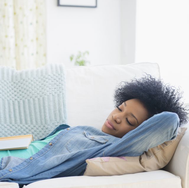 african american woman napping on sofa