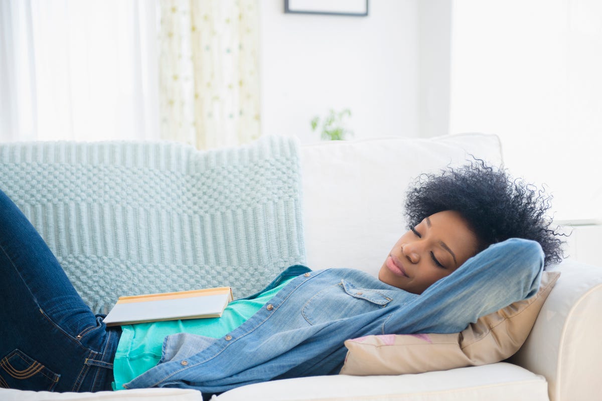 Young Woman Sitting In Bed With Heart Shaped Cushion High-Res Stock Photo -  Getty Images