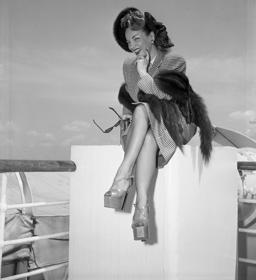 original caption 6171948 new york, ny sporting skyscraper platform shoes, carmen miranda poses prettily on her return from europe aboard the ss america today 617 she was accompanied on her trip by her husband dave sebastian