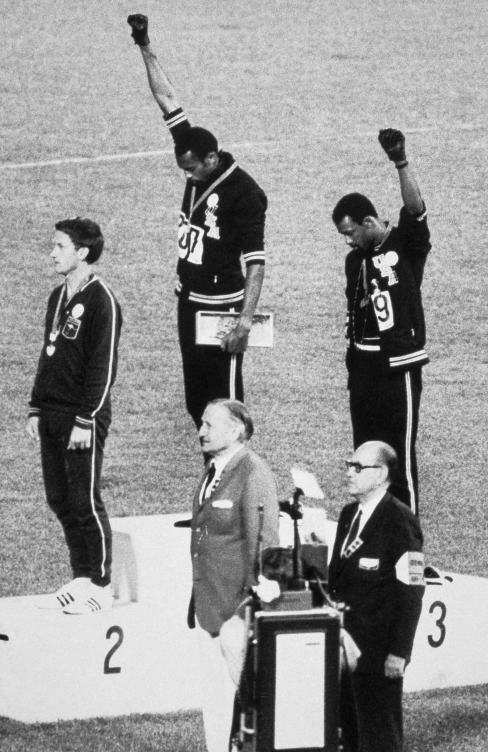 during the award presentation for the men's 200 meter event final at the 1968 summer olympics, american athletes, gold medalist tommie smith center and bronze medalist john carlos right, each raise a clenched fist and bow their heads during the us national anthem as a human rights protest, while they stand on the podium with australian silver medalist peter norman 1942 2006, mexico city, mexico, october 16, 1968 all three men wore badges expressing support for the olympic project for human rights and smith and carlos gestures have been described by the men themselves as both black power and human rights salutes visible at bottom center is the david cecil, the 6th marquess of exeter 1905 1981 who presented the medals photo by bettmanngetty images