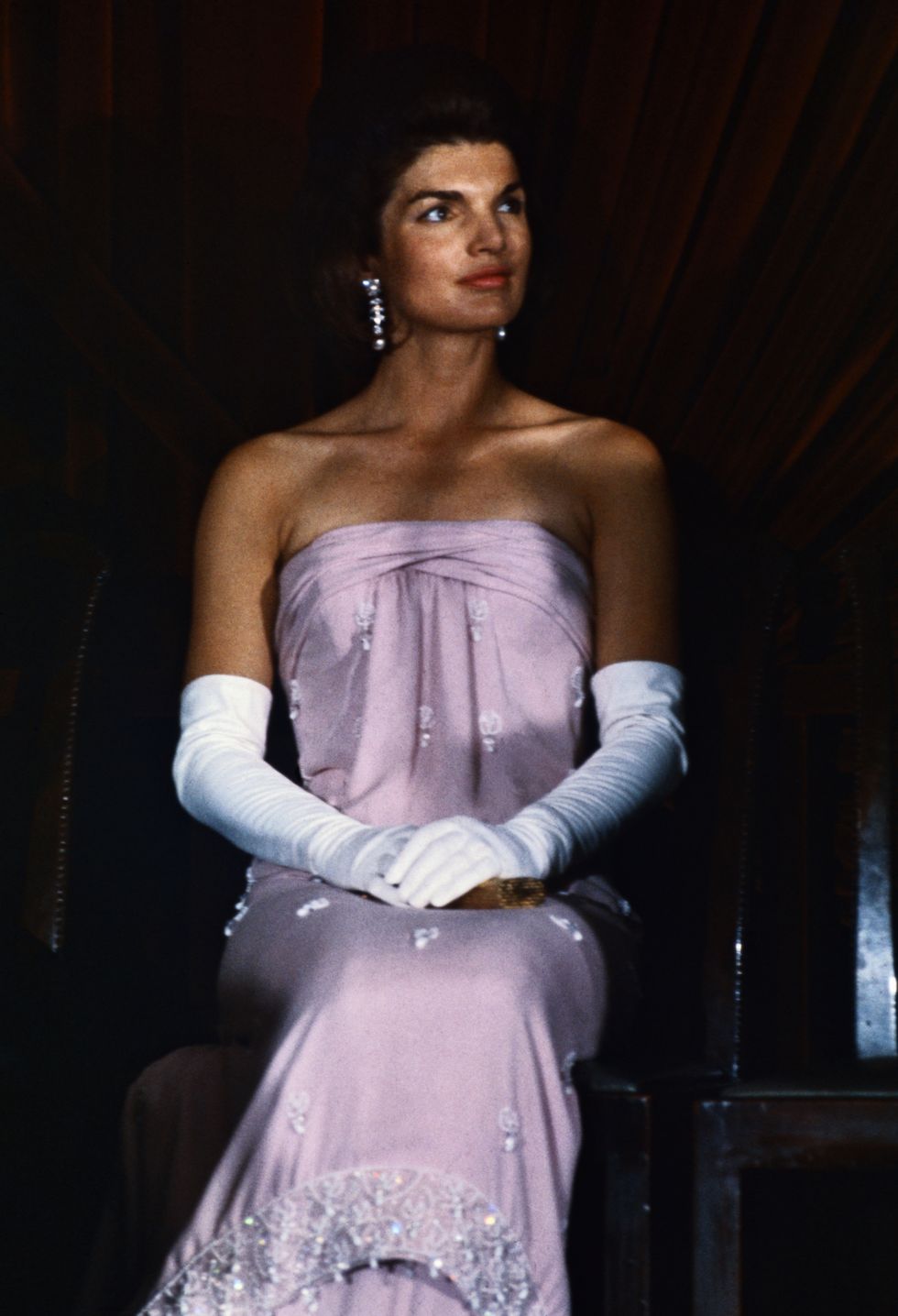 original caption 1863 washington, dc unveiling ceremonies at national gallery of art closeup of first lady jacqueline kennedy in a strapless evening gown and elbow length gloves her hands are folded across her lap