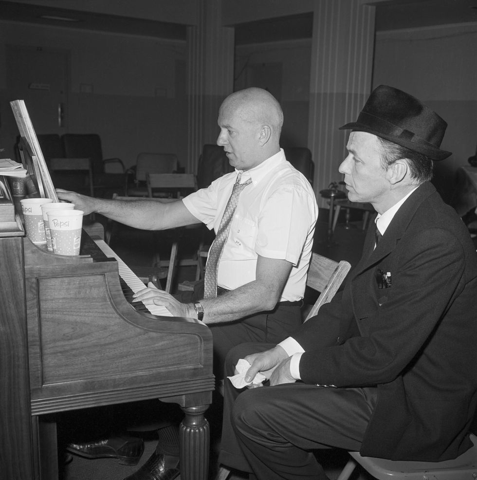 Frank Sinatra sits beside songwriter Jimmy Van Husen at the piano during rehearsal for the inaugural gala