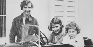 princess elizabeth c and her younger sister princess margaret of great britain play in a miniature automobile while their governess, marion crawford, keeps an eye on them elizabeth will grow up to become queen elizabeth ii