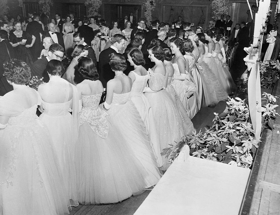 original caption the 19th debutante cotillion and christmas ball was held tonight at the waldorf astoria hotel, launching 106 young women upon the world of society photo shows the greeting line at the colorful affair for the benefit of the new york infirmary