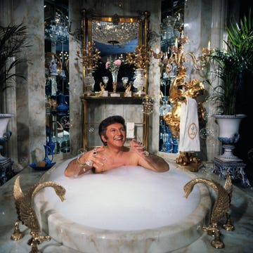 liberace spoofs a day in his own life during a television special, including a scene where he baths in his $55,000 marble bathtub