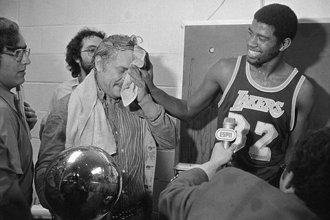 original caption magic johnson r wipes the face of lakers owner dr jerry buss after he poured champagne over him after the lakers beat the sixers 123 107 to win here, 516