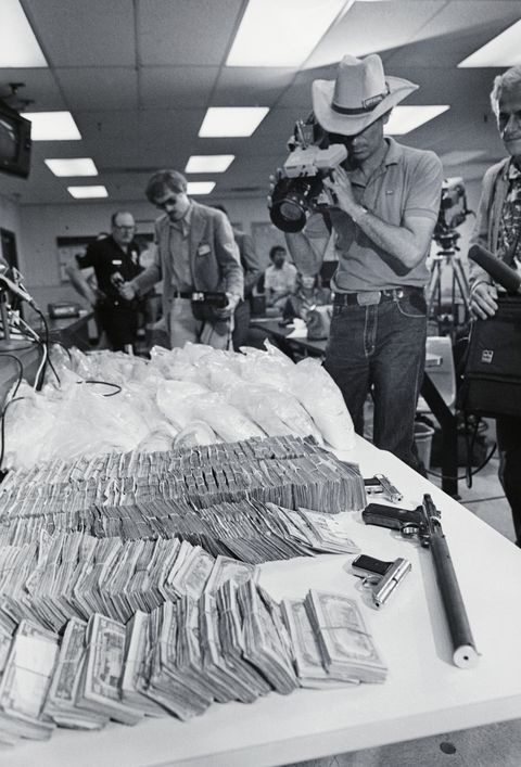 original caption los angeles tv cameraman scans over the 87 pounds of columbian cocaine worth nearly $20 million and the $402, 490 in cash which was seized in a series of nighttime raids 518 four men and a woman were arrested by undercover narcotic officers following an intensive investigation lasting several weeks