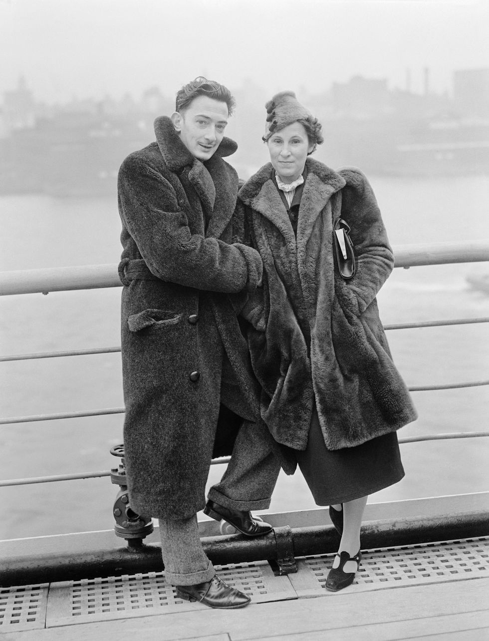 Salvador Dali, the well known Spanish Surrealist painter, and Mrs. Gala Dali, are snapped here aboard the S. S. Normandie upon arrival in New York City on December 7th.