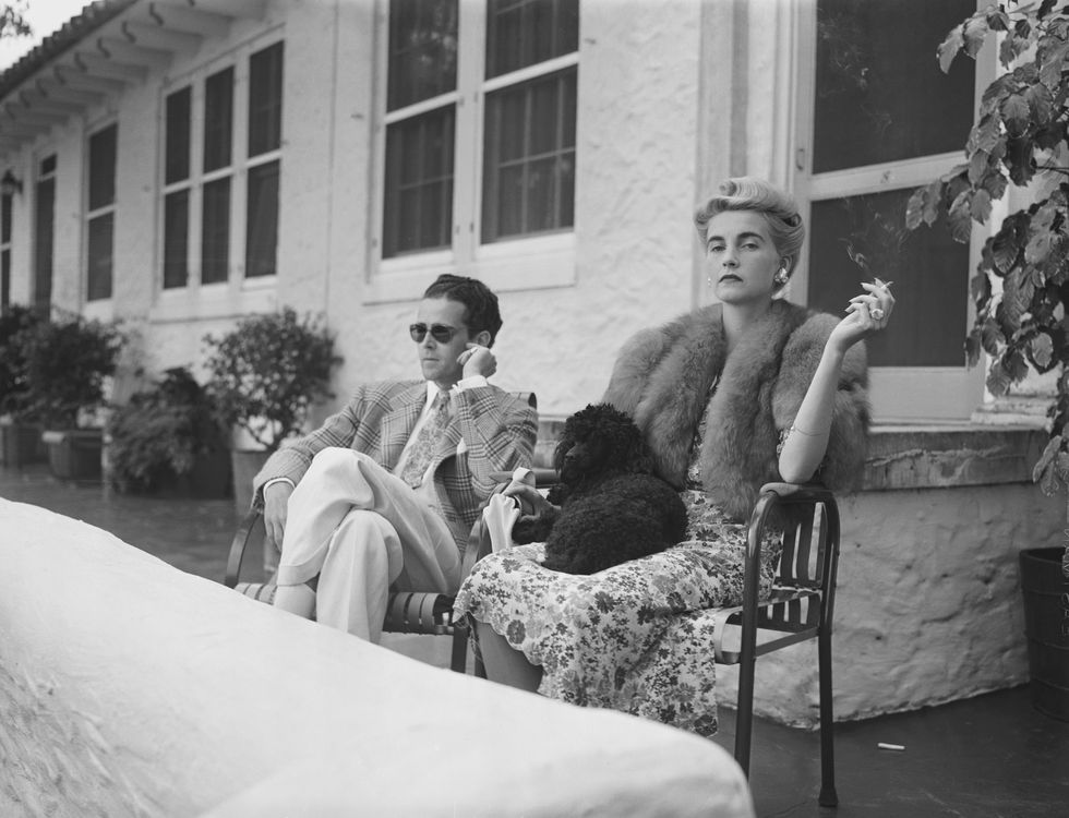 original caption palm beach, florida barbara hutton and constant companion in palm beach countess haugwitz reventlow, the former barbara hutton, and her constant companion since her return from abroad, robert sweeney, as they watch the tennis matches at the everglades club from the everglades apartment veranda