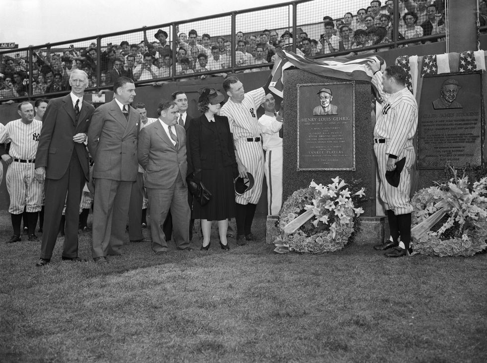 Yankee Stadium was hushed this afternoon just before the twin bill of the Yankees and the Philadelphia Athletics as a memorial tablet to Lou Gehrig, Yankee immortal, was unveiled by Bill Dickey (left), his former teammate, and manager Joe McCarthy. looking on during the unveiling were, left to right, Connie Mack, president and manager of the Athletics; Borough President James Lyons of the Bronx; Mayor Fiorello LaGuardia and Mrs.Gehrig, widow of the great Yankee stalwart.At extreme right is another tablet, in memory of Miller Huggins, former Yankee manager under whom Gehrig got his start as a player.