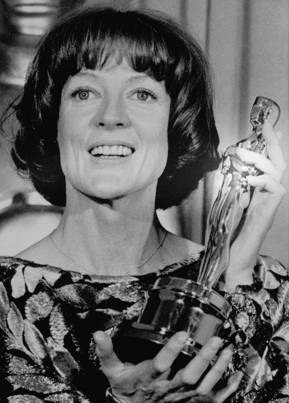 actress maggie smith is all smiles as she holds up her oscar for best actress in a supporting role in the comedy california suite