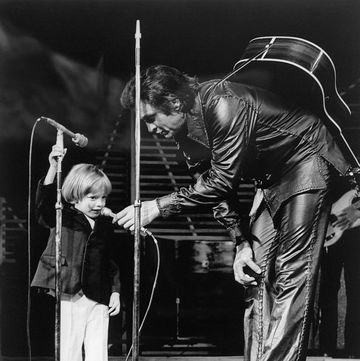 original caption john carter cash, 3 year old son of singer johnny cash, became the youngest person to make a las vegas nightclub debut when he appeared on the stage of the hilton and rendered mary had a little lamb for the sandbox set the proud father is shown holding the microphone down to his son