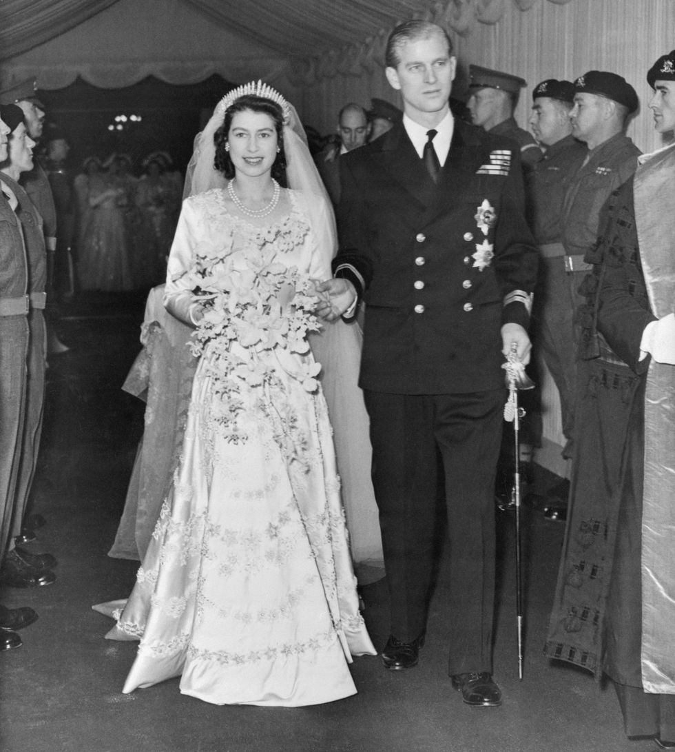 original caption london man and wife eyes shining as she walks up the aisle of westminster abbey with her handsome, blond prince, princess elizabeth radiates happiness, moments after her marriage to prince philip, duke of edinburgh her jeweled wedding gown and the beautiful bride bouquet of orchids can be seen in fine detail in this, the first unposed portrait of the married pair