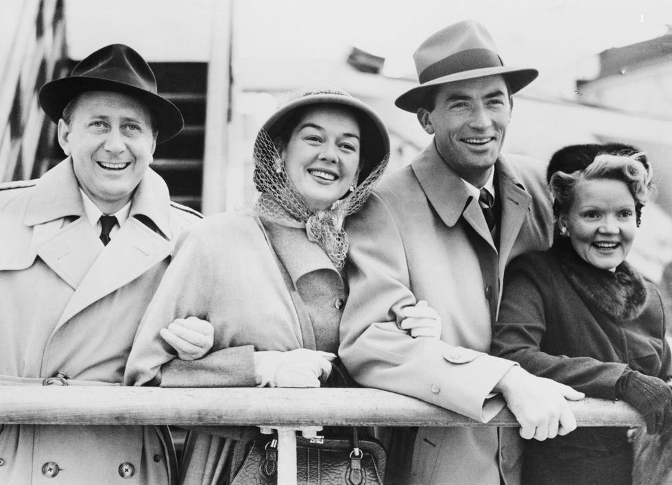 arriving in southampton, england aboard the queen elizabeth are from left movie producer fred brisson and his wife american actress rosalind russell with american actor gregory peck and his wife greta