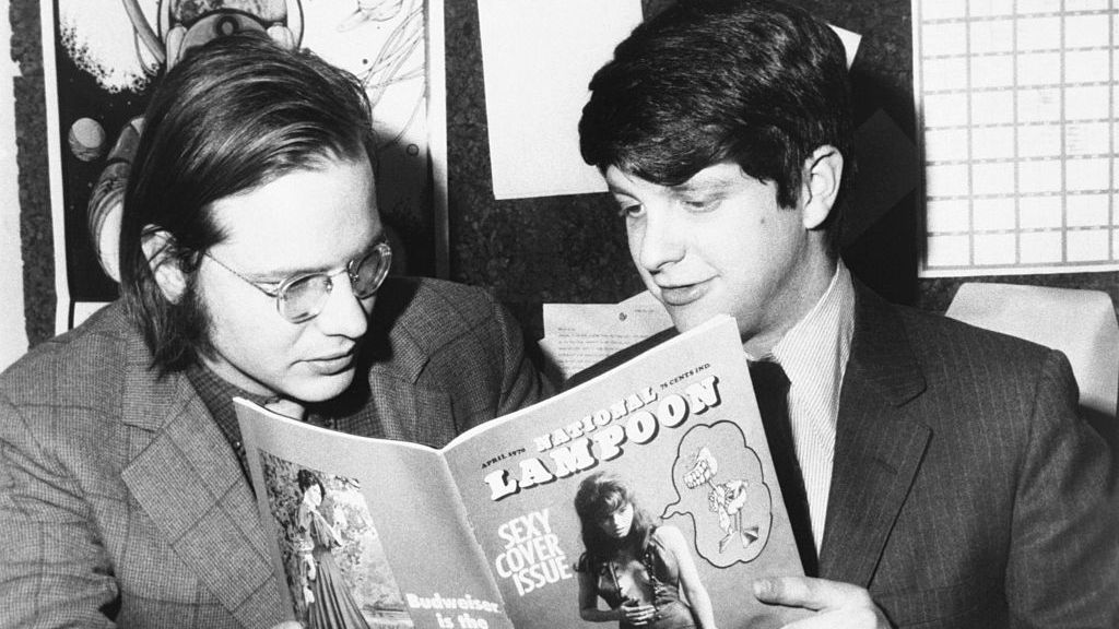 robert hoffman, managing editor, and douglas c kenney, editor, look over the first copy of national lampoon   a monthly humor magazine with each issue treating a separate topic with the satirical style of the famous university magazine it parodies