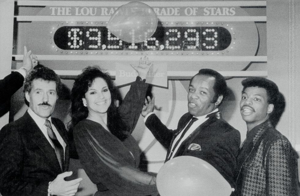 original caption hollywood l r alex trebek, jayne kennedy, lou rawls and levar burton point with pride to the tote board of the seventh annual lou rawls parade of stars telethon as the shows live feed ends late december 28 they money raised will support the education of more than 45,000 students as 45 private, historically black colleges that are part of the united negro college fund the nearly $10 million shown on the board is a preliminary total as additional pledges are expected as the show continues in other cities
