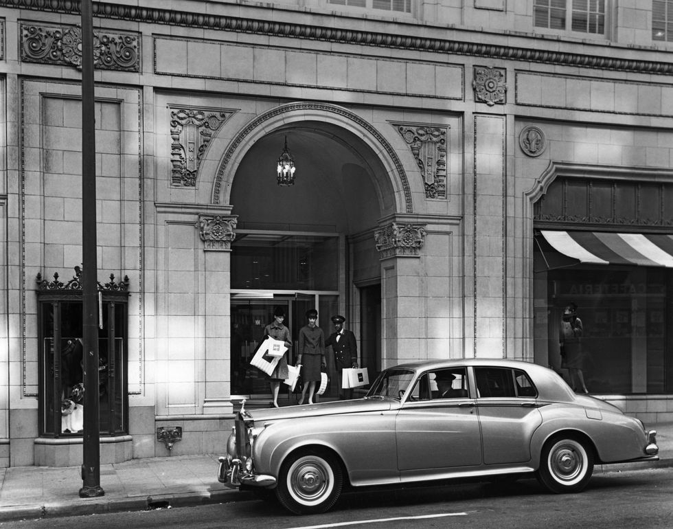 original caption ca 1945 1960 the ervay street entrance for neiman marcus in dallas, tx two women leave, a doorman holds their packages and the door for them they are walking towards a waiting car