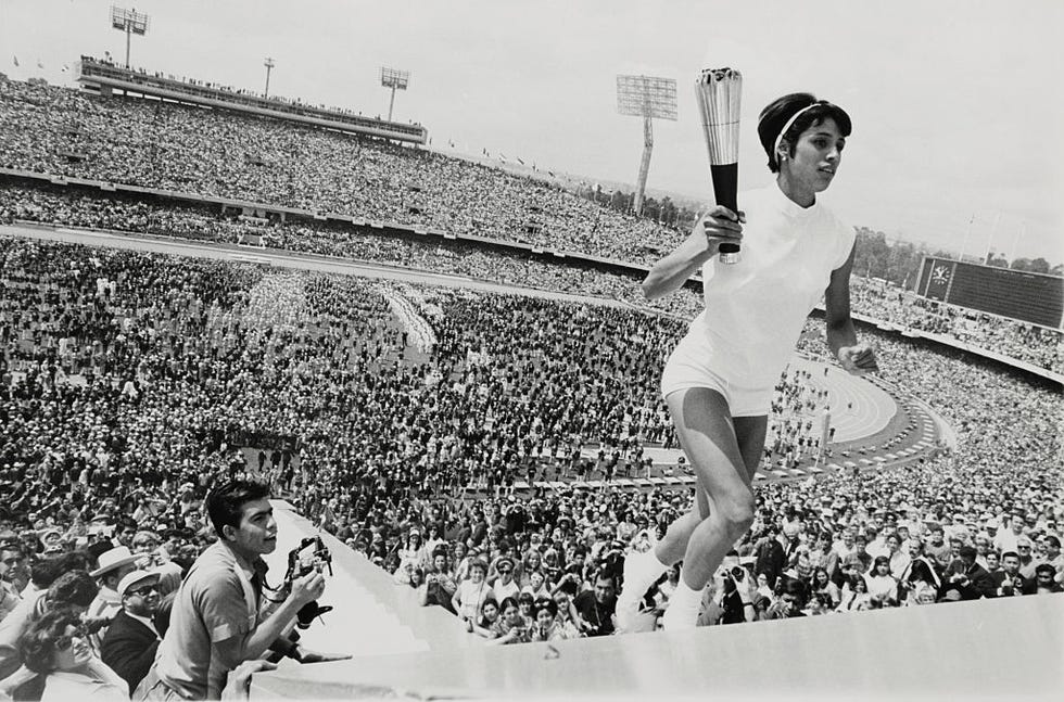 original caption mexico city mexicos norma enriqueta basilio, the first woman in the history of the modern olympic games to light the olympic fire, runs up the ninety steps with the olympic torch during the opening ceremonies here october 12, 1968