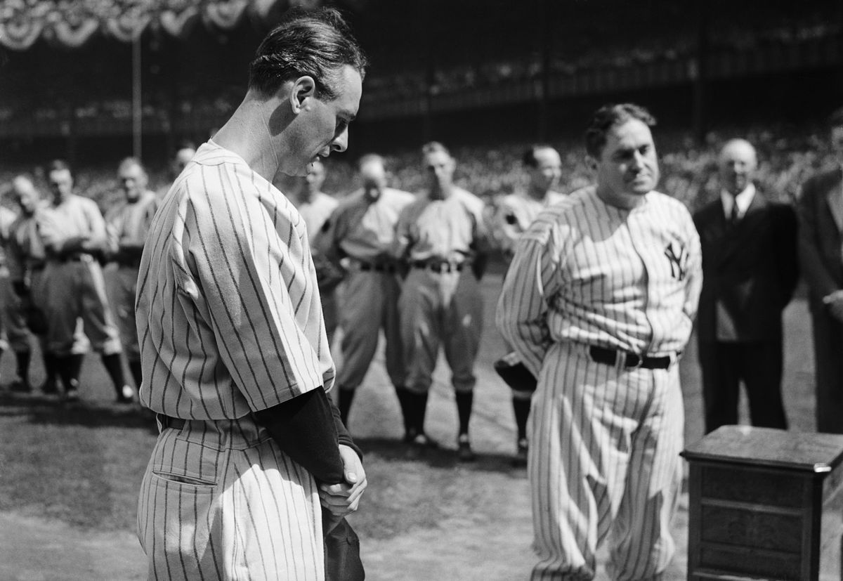 Iron man Lou Gehrig, first baseman for the Yankees, whom sickness benched, stands with his head bowed as tears well into his eyes during the ceremonies honoring him at Yankee Stadium. Sixty thousand fans and many famous figures of baseball were present for the ceremonies.