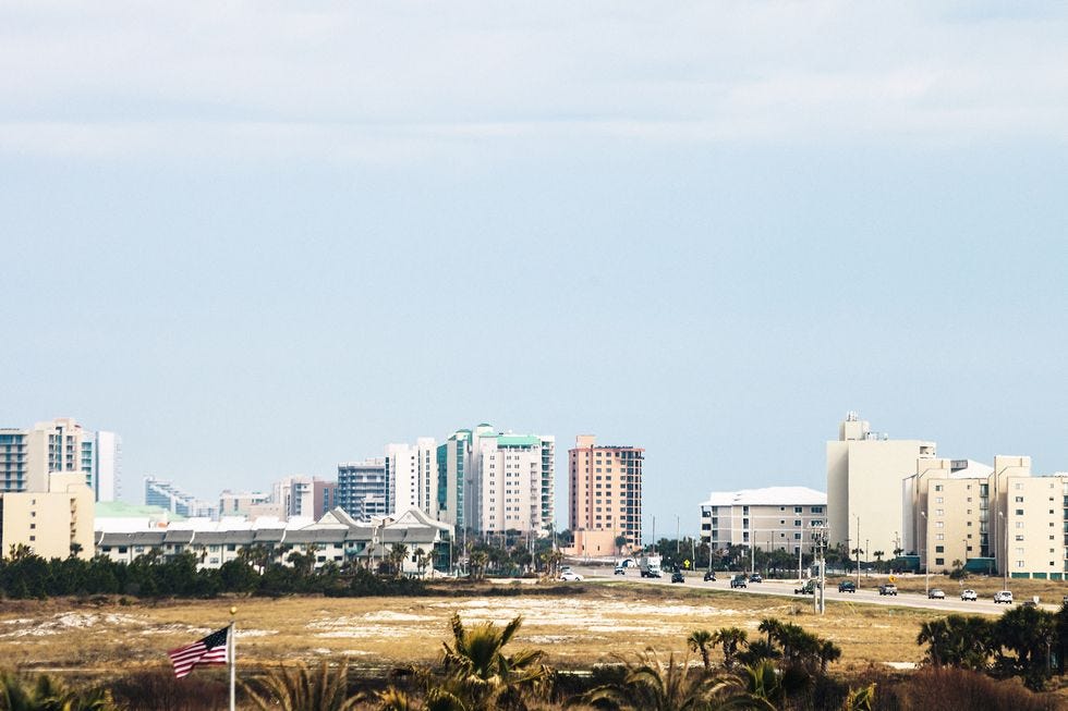a beach with tall buildings