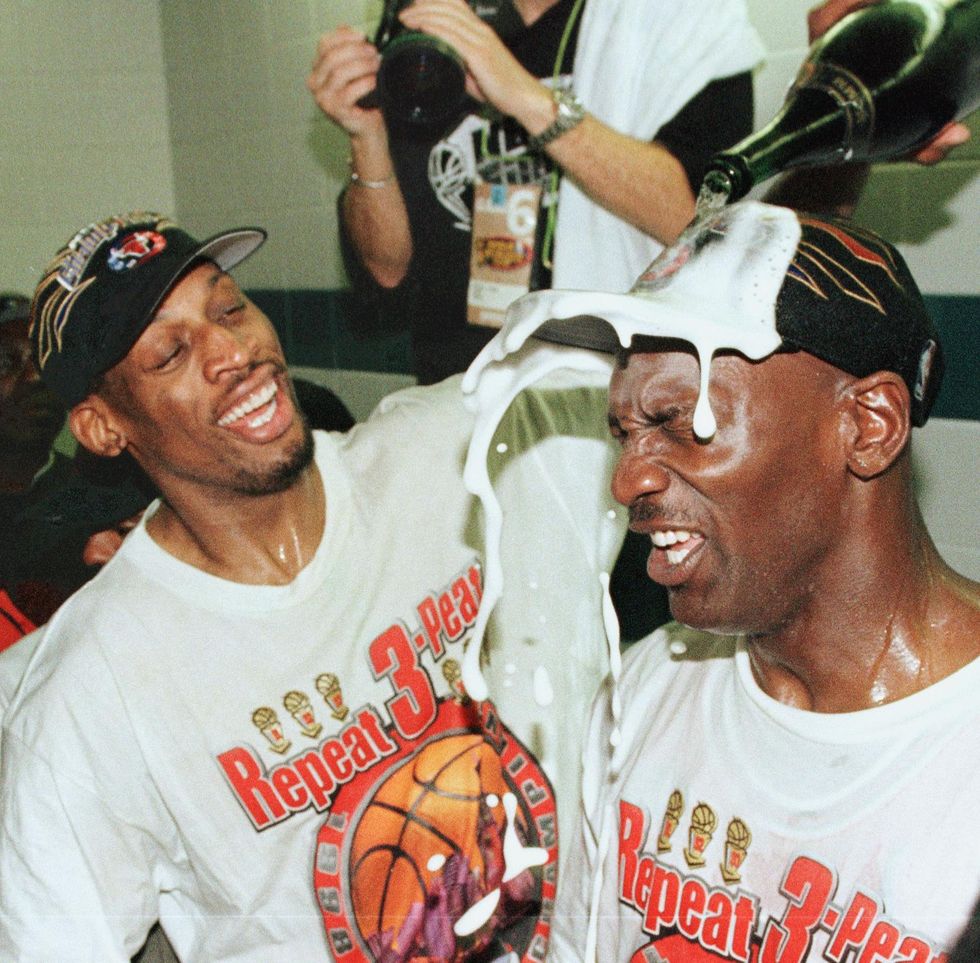 salt lake city, united states  dennis rodman l of the chicago bulls pours champagne on the head of teammate michael jordan r 14 june after winning game six of the nba finals with the utah jazz at the delta center in salt lake city, ut the bulls won the game 87 86 to win their sixth nba championship   afp photomike nelson photo credit should read mike nelsonafp via getty images
