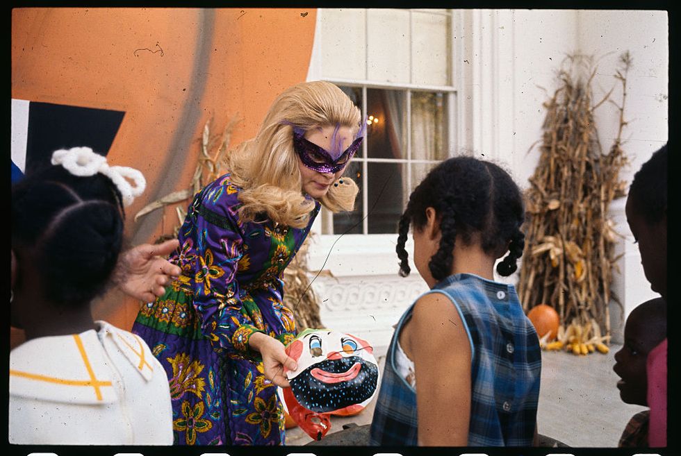 original caption tricia nixon greets guests at the north portico entrance of the white house, 103169 as some underprivileged washington area children came to the white house for a halloween party