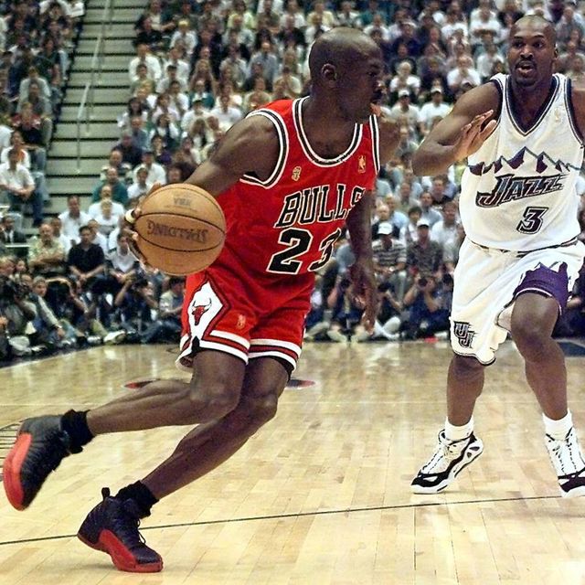 salt lake city, united states  michael jordan l of the chicago bulls goes to the basket past bryon russell of the utah jazz 11 june during game five of the 1997 nba finals at the delta center in salt lake city, utah the best of seven series is tied at 2 2   electronic image     afp photojeff haynes photo credit should read jeff haynesafp via getty images